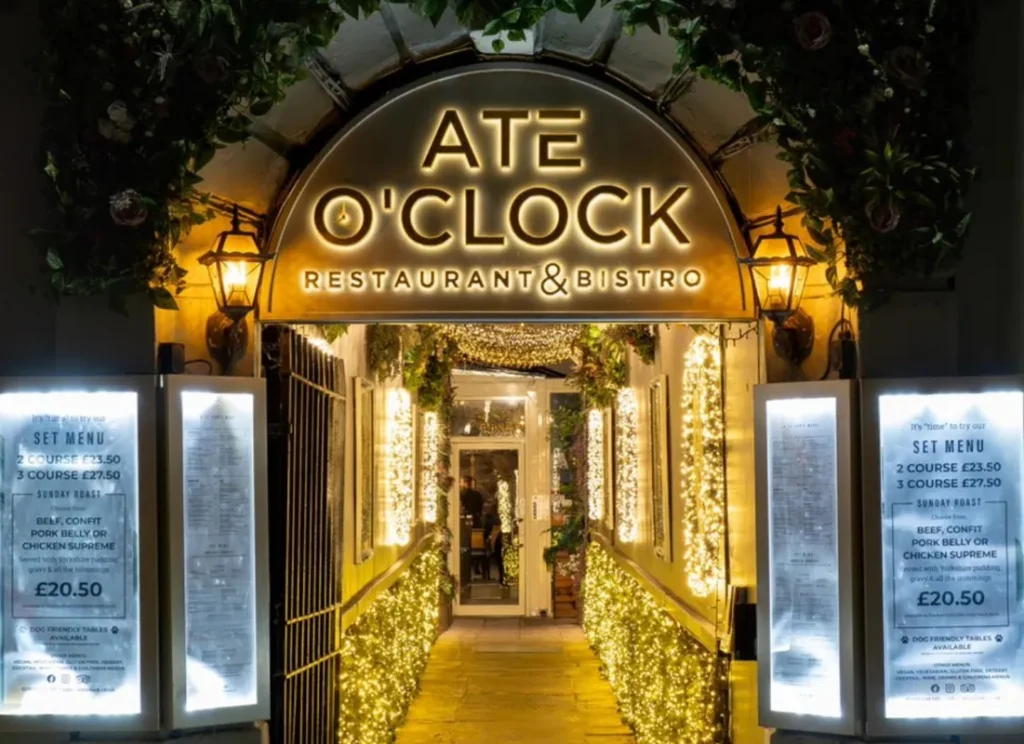 Ate O’Clock restaurant entrance in York near Hocus Pocus Tiny Hotel lit with decorative lights