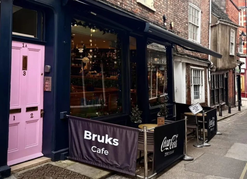 Bruks Cafe exterior with pink door in York near Hocus Pocus Tiny Hotel